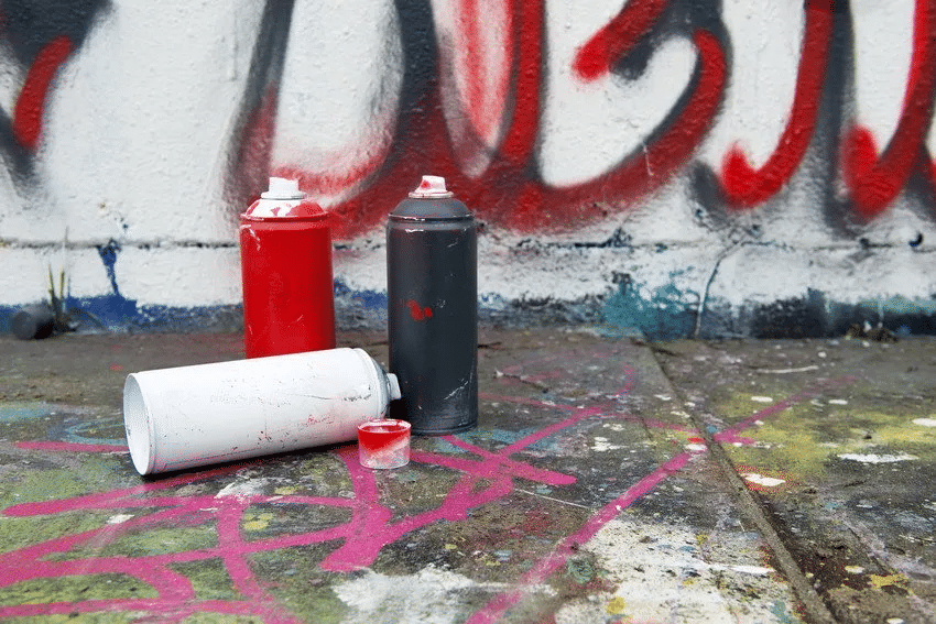 graffiti cans near wall