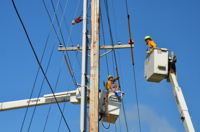 cherry picker at electricity lines